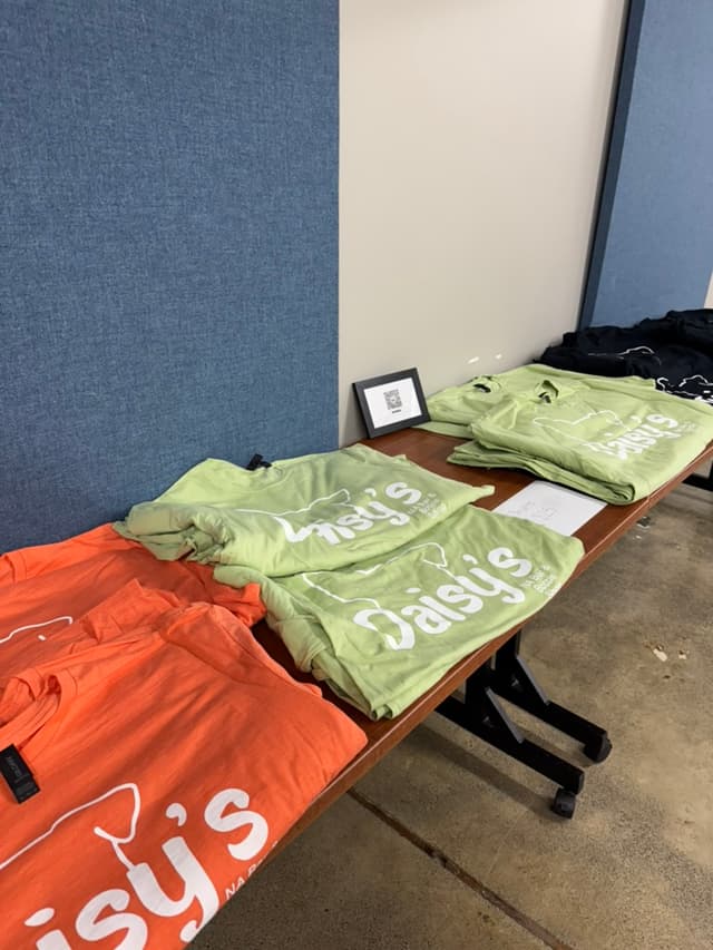 Daisy's branded t-shirts and merchandise display