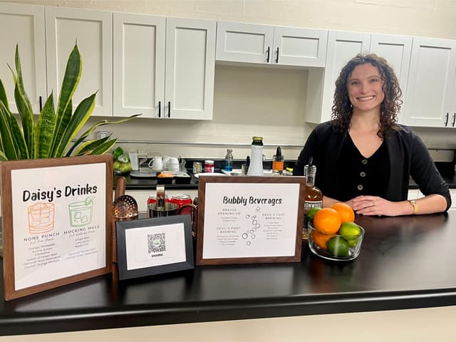 Professional bartender crafting mocktails at Daisy's